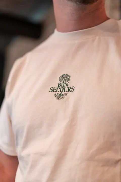 Cream T-shirt with a green embroidered Bon Secours logo