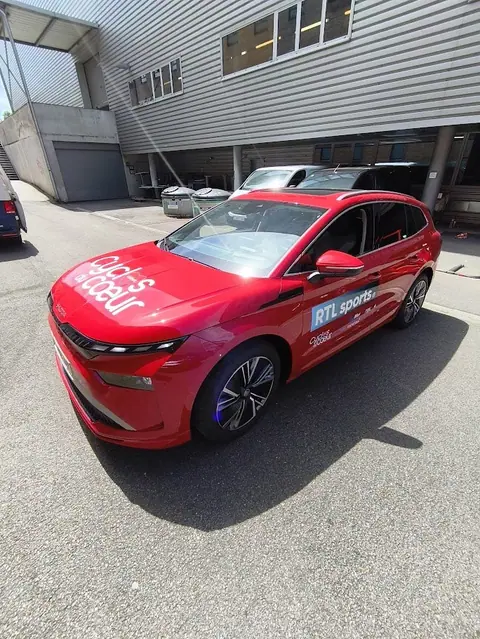 Red Skoda car in the campaign colours, parked in a car park