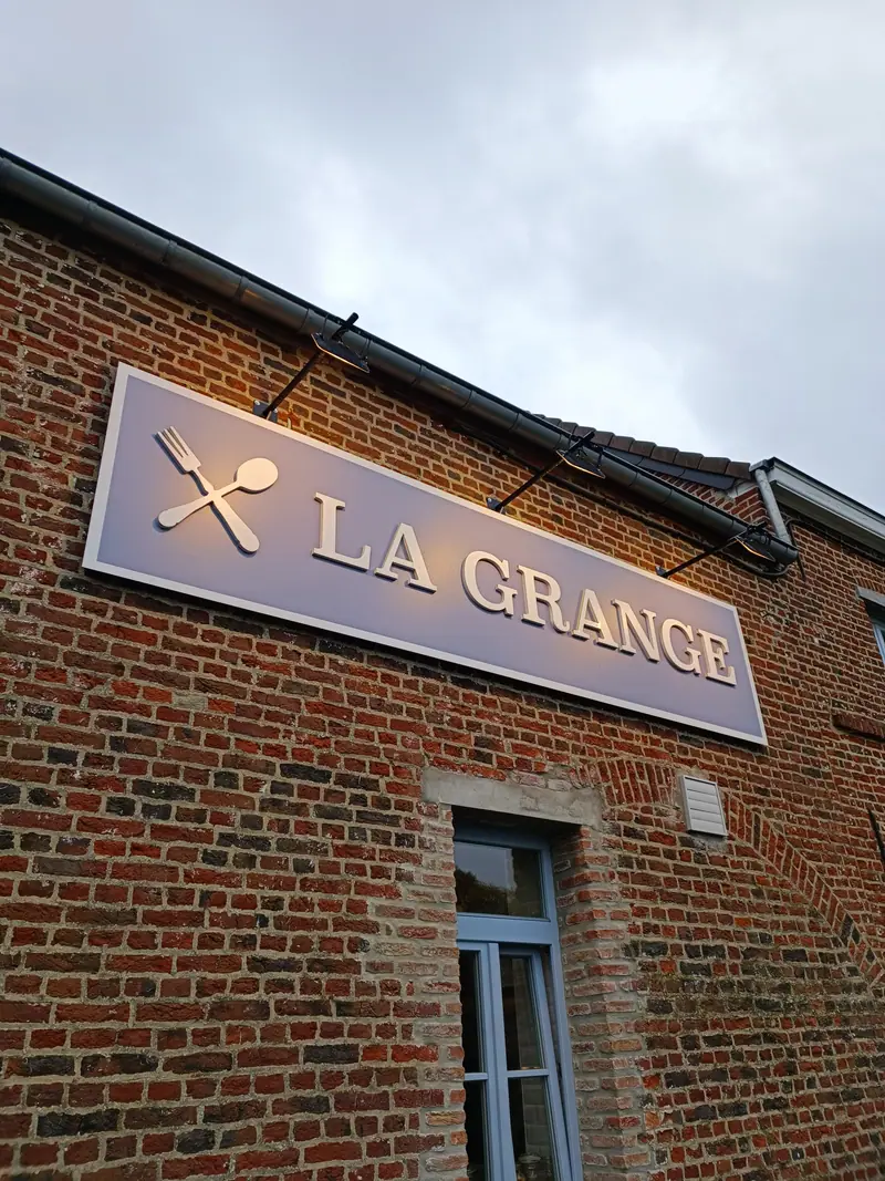 La Grange sign fixed to the brick façade of the restaurant