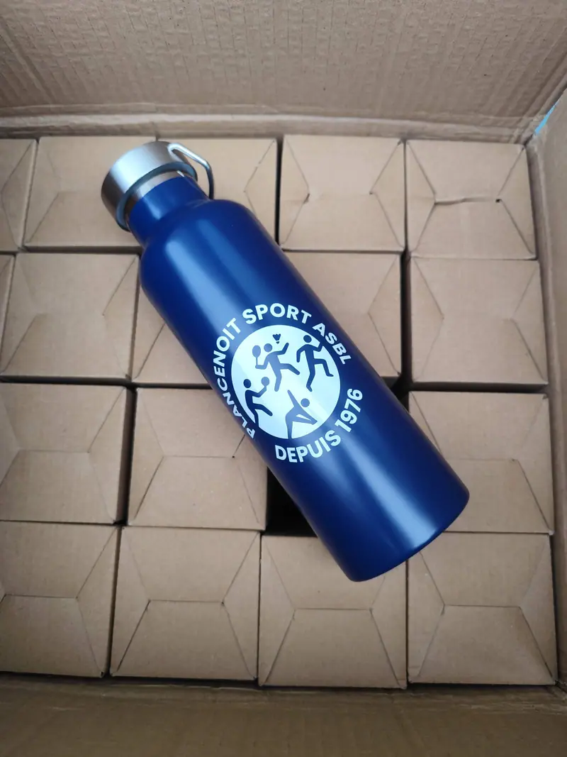 Blue Plancenoit Sport water bottle engraved with the club logo on top of boxes