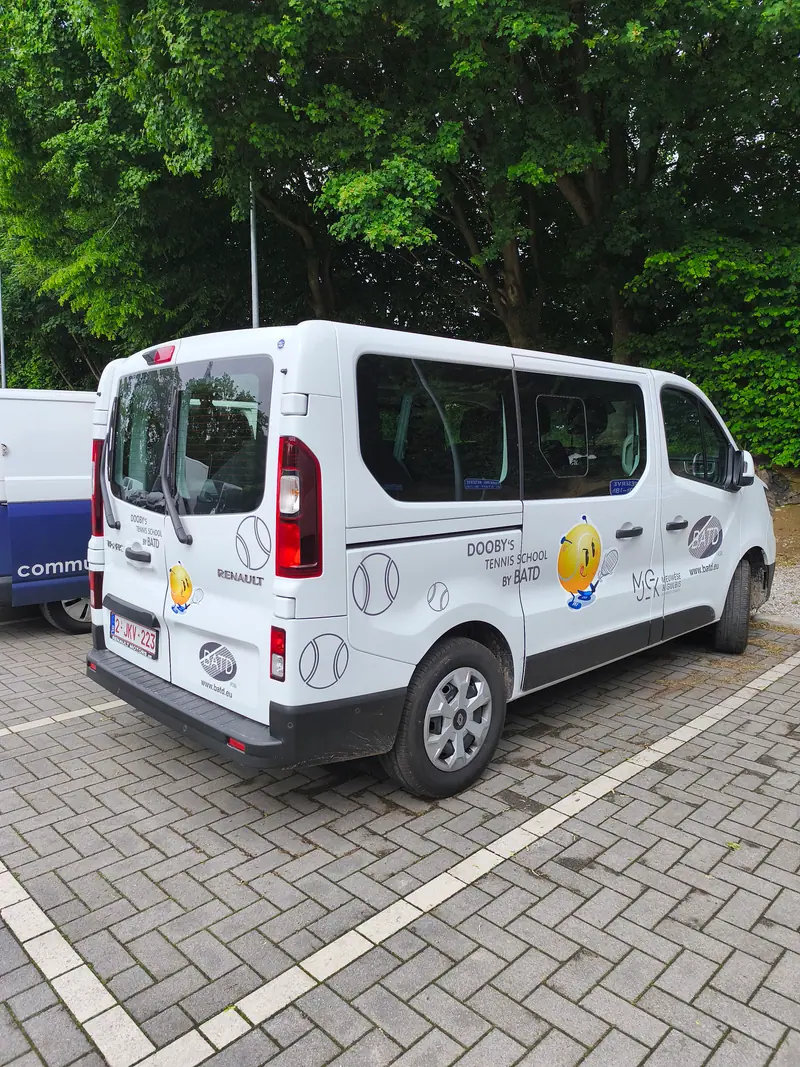 White Dooby’s Tennis School minibus decorated with tennis balls