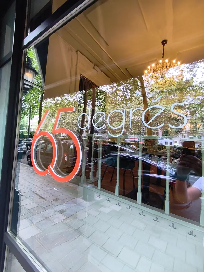 65 degrés logo as window graphics on a shop window