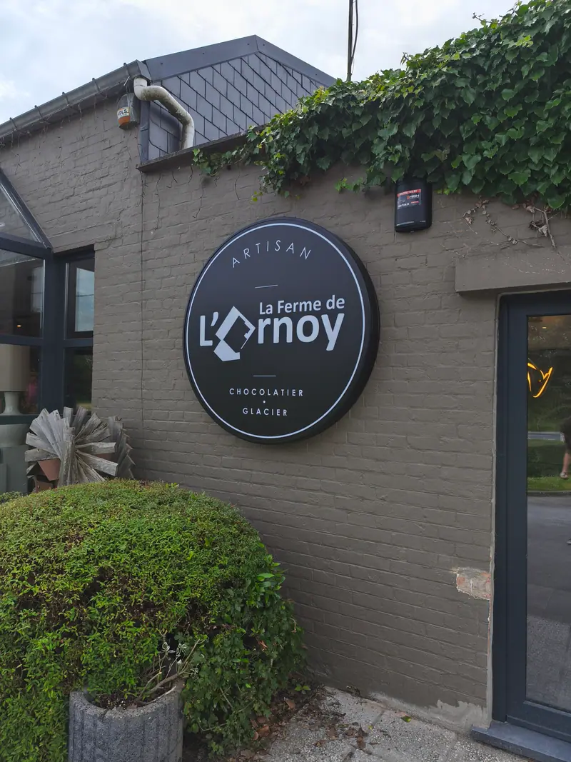 Round sign for La Ferme de l’Ornoy, chocolate maker and ice cream parlour