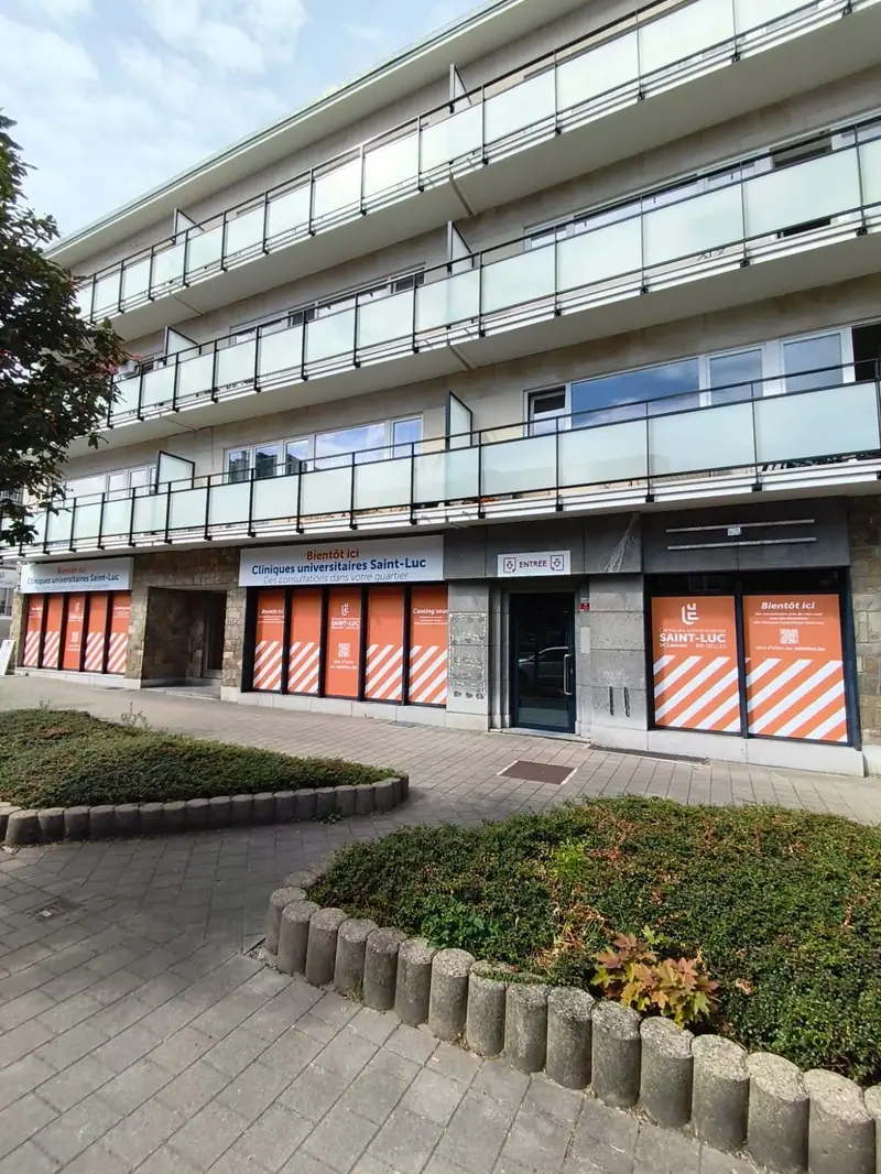 Ground floor of an office building dressed with orange and white printed graphics
