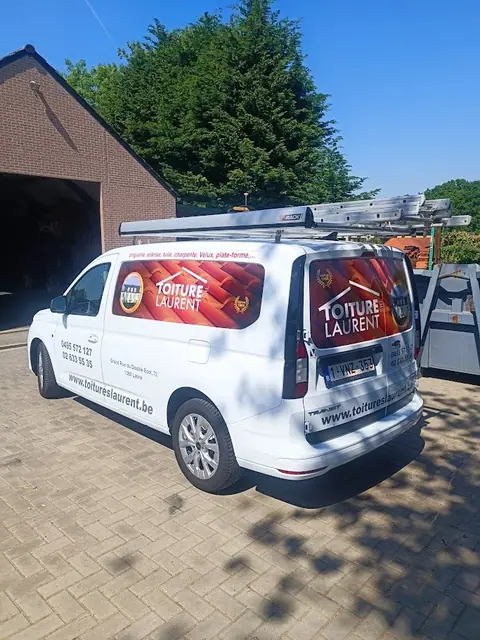 White van dressed with red and black printed graphics