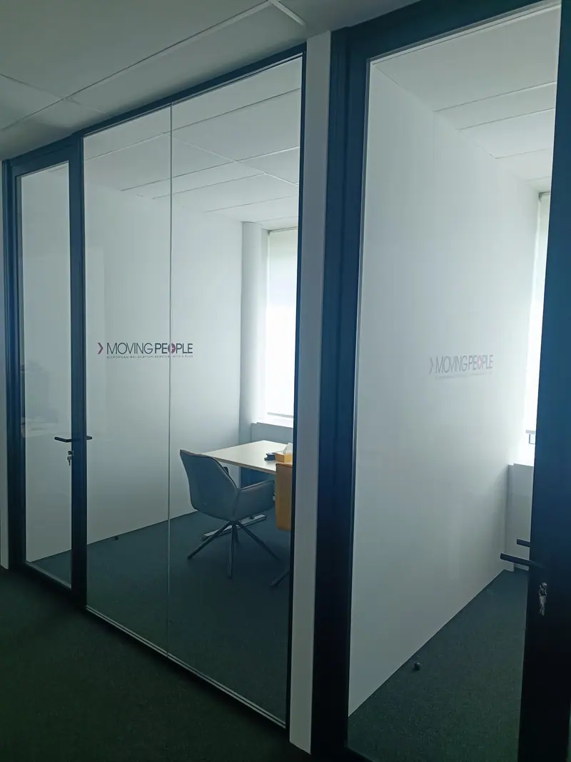 Moving People logo applied as window graphics on the glass partitions of two offices