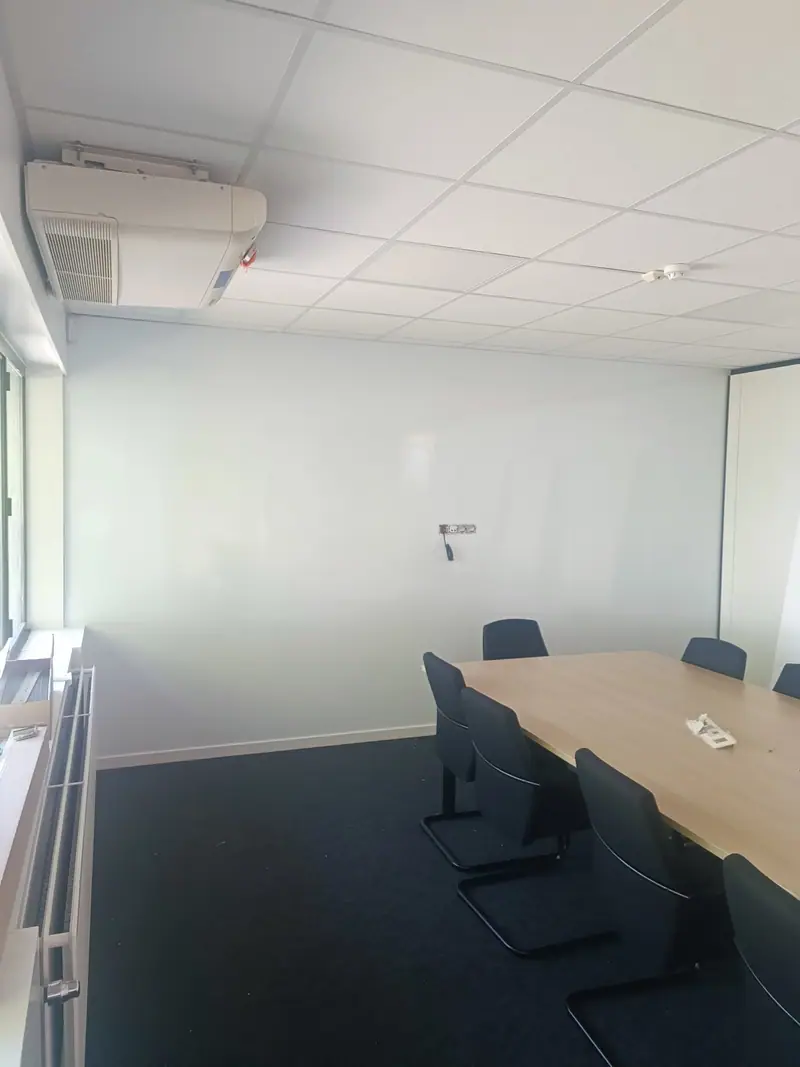 Moving People meeting room with a wall-mounted whiteboard