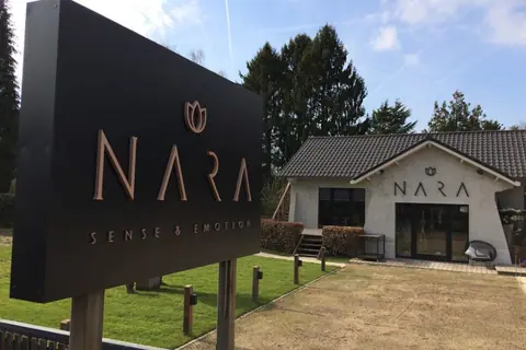 Nara Sense & Emotion sign with copper letters on a black background