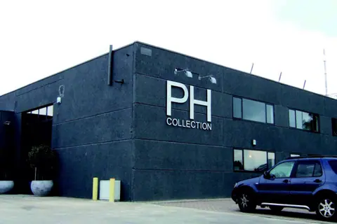 PH Collection logo in white letters on the façade of a dark building