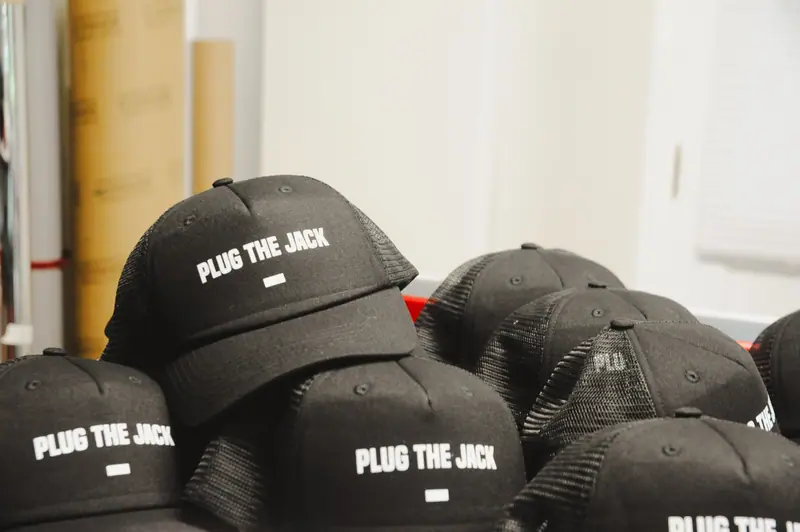 Black Plug the Jack caps printed in white letters