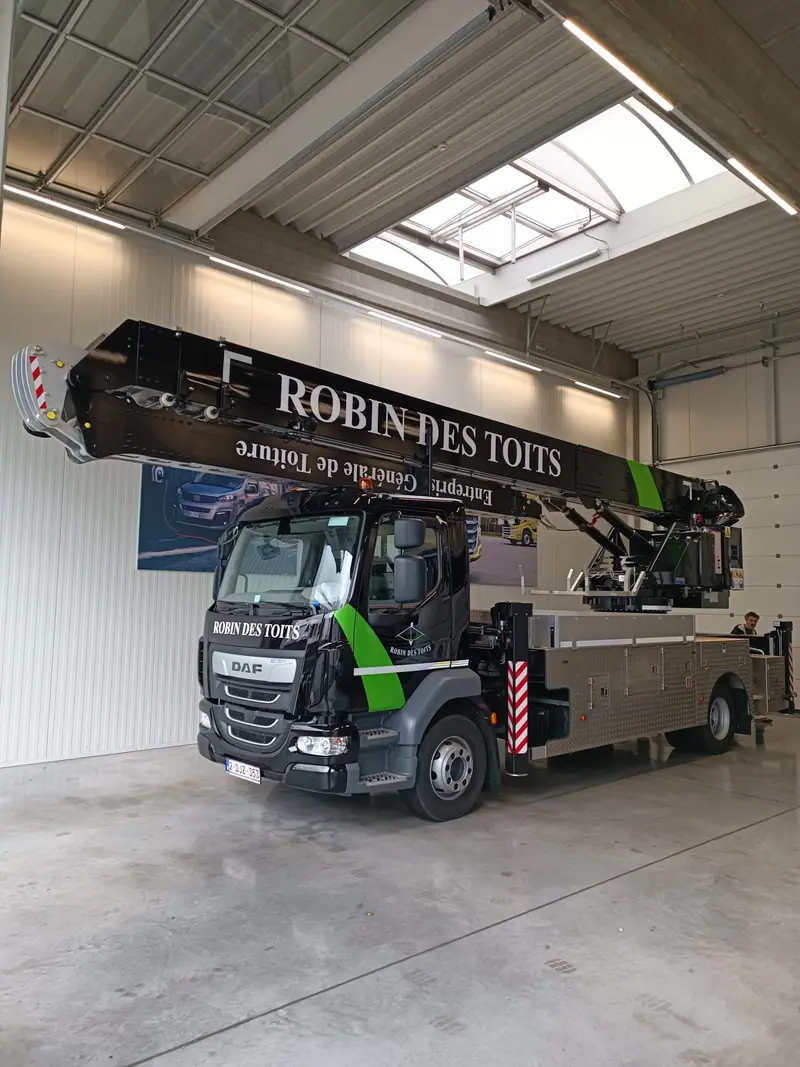 Black and green Robin des Toits aerial lift truck with white lettering